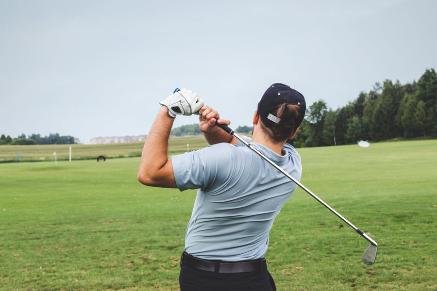 Male Golfer swinging on a practice course